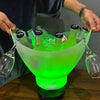 7L Bluetooth LED Ice Bucket with Subwoofer filled with drinks and illuminated in green, showcasing party essentials.