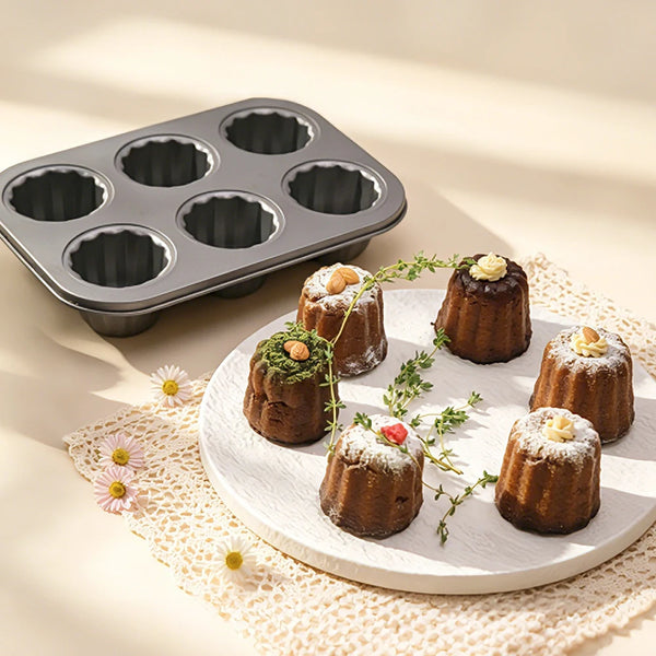 Carbon Steel 6-Cup Cannelé Baking Tray with finished canelé pastries arranged on a plate.