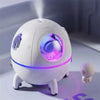 Astronaut Space Capsule Humidifier with LED Light 220ml emitting mist with mini astronaut figure beside it.