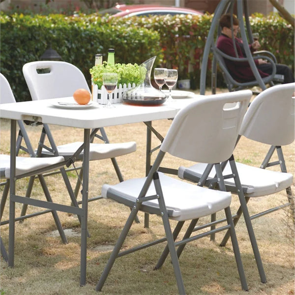 Foldable Plastic Outdoor Chair with Metal Frame set around a table in a garden setting for events and gatherings.