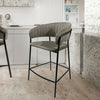 Upholstered Bar Stool with Curved Back and Black Metal Frame in modern kitchen setting.