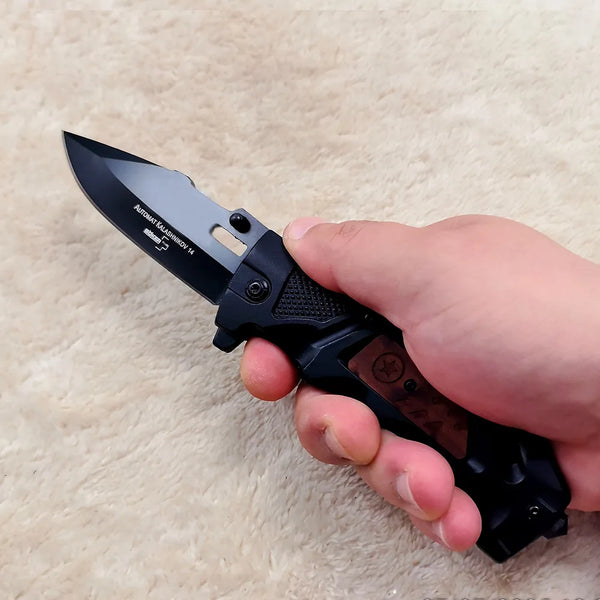 Non-Slip Stainless Steel Folding Meat Knife held in a hand, showcasing its sharp blade and ergonomic grip.