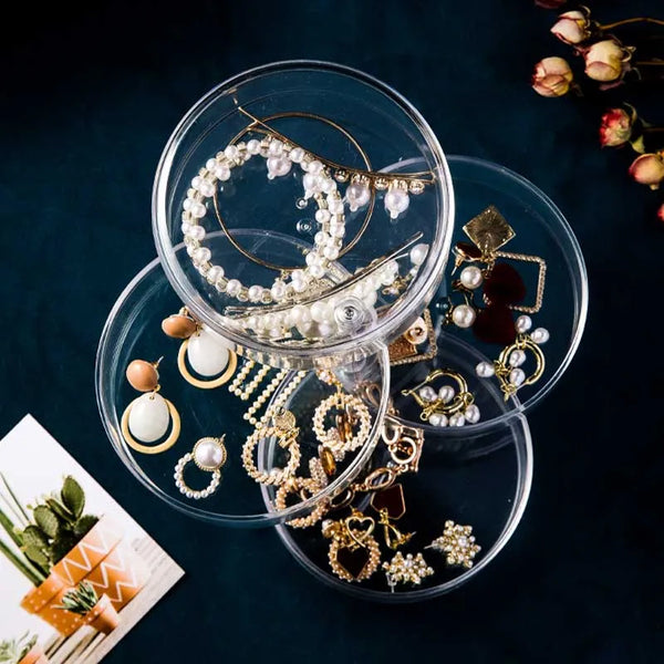 Clear 360 Rotatable Jewelry Box displaying various earrings and necklaces in a stylish and organized manner.