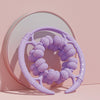 32 Wheel Ring Muscle Relaxation Leg Massager in purple color displayed against a mirror background.