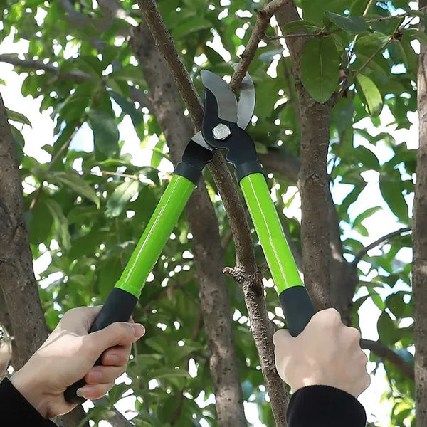 Two hands using a Heavy-Duty Garden Pruning and Lopper Kit to trim branches in a garden.