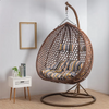 Top Quality Outdoor Magic Rattan Single Sofa Chair hanging in a stylish, modern indoor setting with cushions.