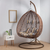 Top Quality Outdoor Magic Rattan Single Sofa Chair hanging in a stylish, modern indoor setting with cushions.