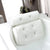 Non Slip Take Bath Pillow with Suction Cups placed on the edge of a bathtub for comfortable bathing.
