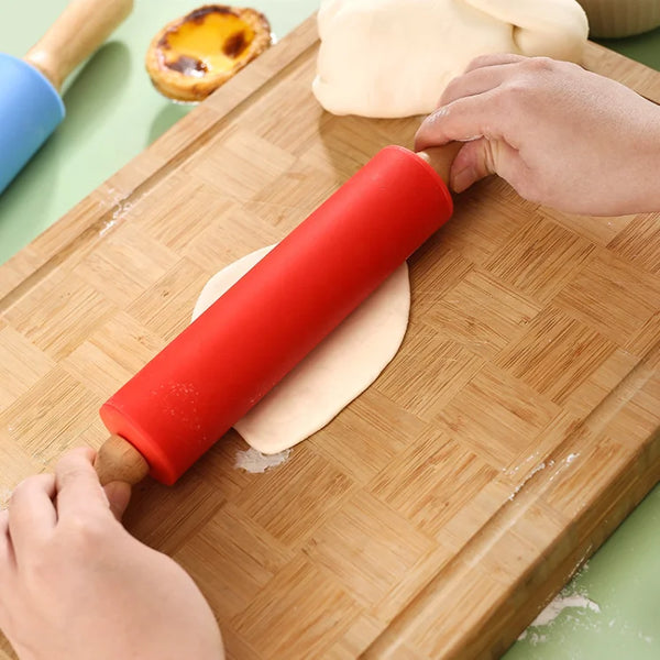Non-Stick Wooden Handle Silicone Rolling Pin being used on dough on a wooden board.