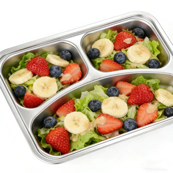 304 Stainless Steel 3 Compartment Lunch Box filled with fresh salad, strawberries, blueberries, and banana slices.