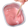 Painless Strawberry Hard Wax Block being stirred to a creamy consistency in a small metal container.