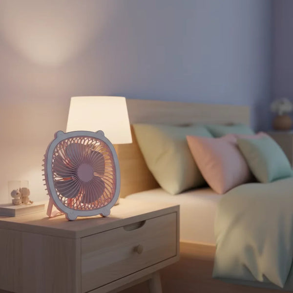Fresh Color Box Desk USB Fan Rechargeable Cooling Fan on bedside table in a cozy bedroom setting.