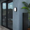Waterproof Outdoor LED Corridor Ceiling Lamp illuminating a modern exterior wall beside a large window.