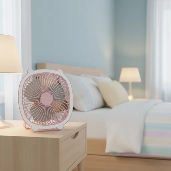 Fresh Color Box Desk USB Fan Rechargeable Cooling Fan on a bedside table in a decorated bedroom.