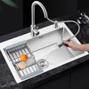 Single Bowl Stainless Steel Kitchen Sink with fruits being washed under spray faucet.