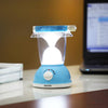 Portable Rechargeable Camping Lantern providing bright light on a table next to a laptop.
