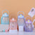 Large 1.1 L Hydration Water Bottle collection in pastel colors with motivational quotes for hydration.