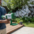 Light-Up Bubble Bazooka Machine Gun producing a stream of bubbles during outdoor playtime with a person holding it.