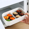 Lightweight Microwave-Safe Bento Lunch Box with sushi and a side dish being placed in a microwave.