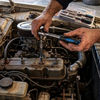 A mechanic using the Professional 6-Piece Ratchet and Accessory Kit to work on an engine.