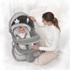A mother gently soothing her baby in the Deluxe Multi Functional 4 in 1 Baby Bassinet.