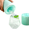 A person pouring ice cubes from a Mini Reusable Cooling Gel Ice Pack into a glass filled with ice and mint.