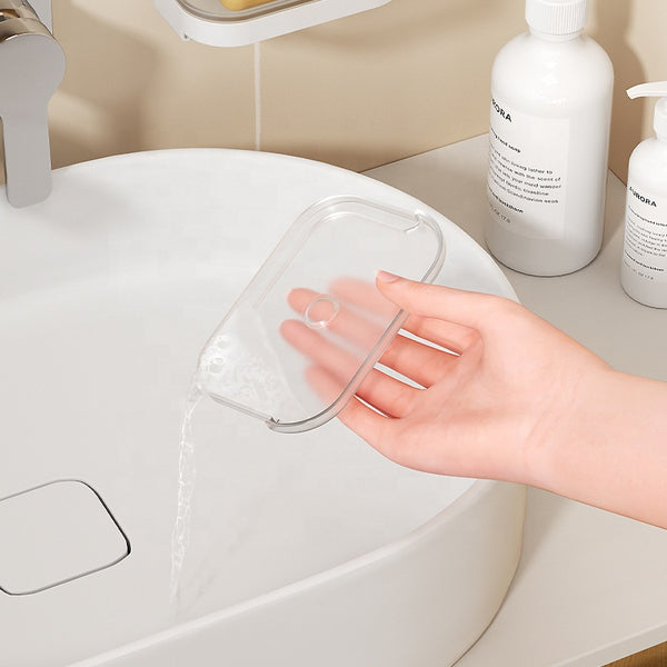 Hand holding a Modern Wall-Mounted Shower Soap Holder over a sink, showcasing its sleek design and functionality.