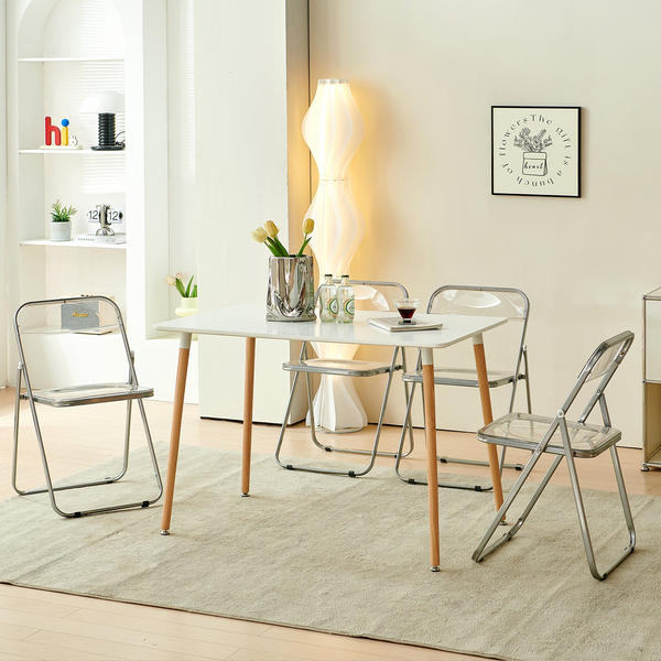 Modern Transparent Folding Chair set around a sleek dining table in a contemporary living space.