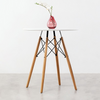 75cm Modern Eames Design Round Dining Table with minimalist design and a vase with flowers on top.