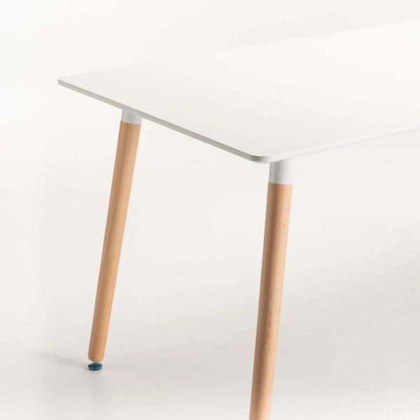 Close-up of Betty Wooden Leg Dining Table showing white tabletop and wooden legs, ideal for modern dining spaces.