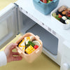 Portable 800ml Kids Bento Lunch Box with Handle being taken out from a microwave.