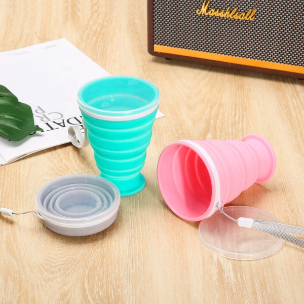 Portable Collapsible Silicone Travel Cup in turquoise and pink, compact design, perfect for on-the-go hydration.