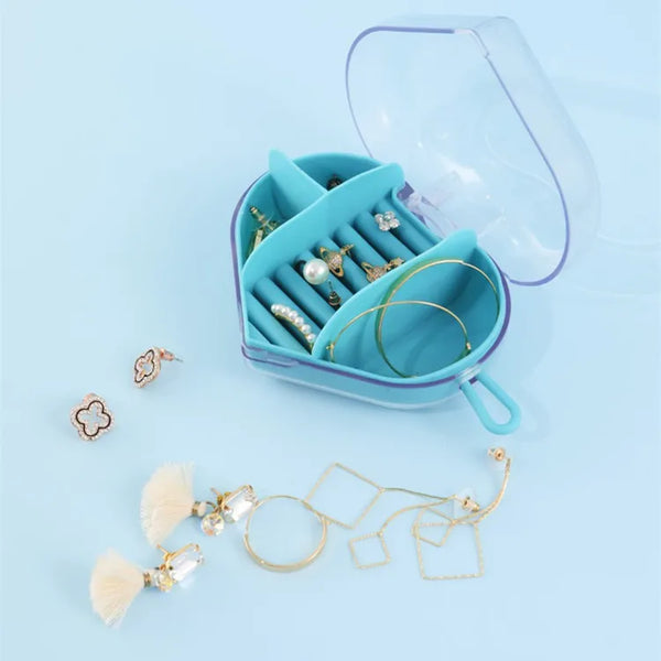 Portable Heart-Shaped Acrylic Jewelry Storage Box featuring organized earrings and rings in a compact blue case.