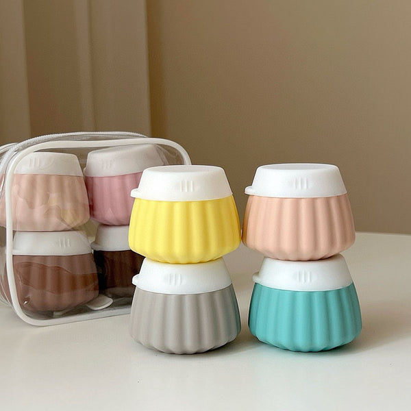 Portable travel silicone bottle set in various colors, neatly organized for travel storage.