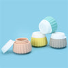 Portable travel silicone bottle set featuring four colorful, ribbed bottles on a blue background.