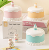 Portable LED Cake Desk Lamp in pink, yellow, and blue with figurines, ideal for bedside table lighting.