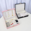 Premium Multi-Compartment Jewelry Box in pink and black, showcasing organized jewelry compartments for accessories.