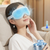 Cooling Gel Eye Mask worn by a woman relaxing at home, featuring a blue cooling design and soothing effects.