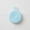 Silicone Care Hair Silicone Scalp Massager in blue circular design for effective scalp exfoliation and stimulation.