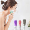 Woman using silicone refillable shampoo lotion bottles to apply skincare in pastel colors.