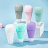 Silicone refillable shampoo lotion bottles in various colors displayed on a light blue background, ideal for travel organization.