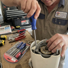 Professional using a 4-Piece Magnetic Precision Screwdriver Set for repairs on an appliance.
