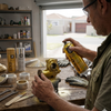 Man using Automatic 450ml Multi Surface Gold Spray Paint Can on a decorative project in a workshop.