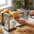 Using a Stainless Steel Spiral Potato Slicer to create spiral potato slices in a kitchen setting.