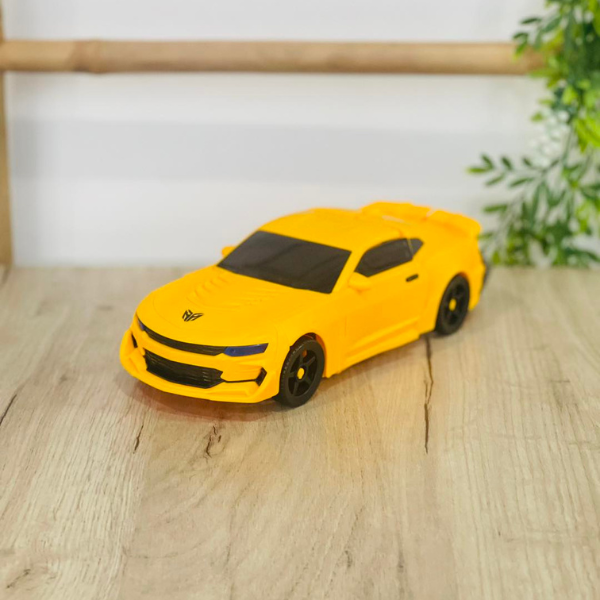 Sliding Transform Mini Robot Car Toy in vibrant yellow color on a wooden surface.