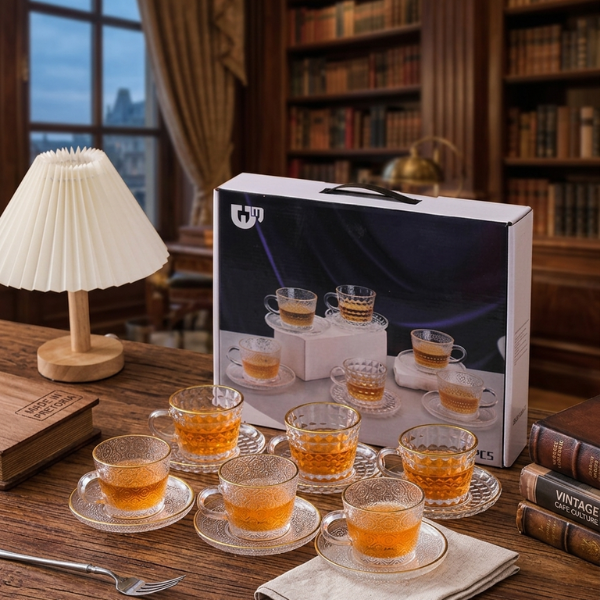 12 Piece Embossed Glass Coffee Cup and Saucer Set displayed on a wooden table with tea in elegant cups and saucers.