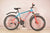 Aluminum Alloy 21 Speed Men Cycle Mountain Bike with blue and red design, suitable for trails and city riding.