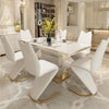 White & Gold Dining Room Table Set featuring a modern design with elegant white chairs and a glossy tabletop.