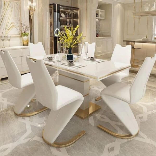 White & Gold Dining Room Table Set featuring a modern design with elegant white chairs and a glossy tabletop.