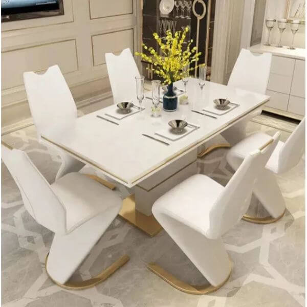 White & Gold Dining Room Table Set featuring a modern design with elegant white chairs and floral centerpiece.